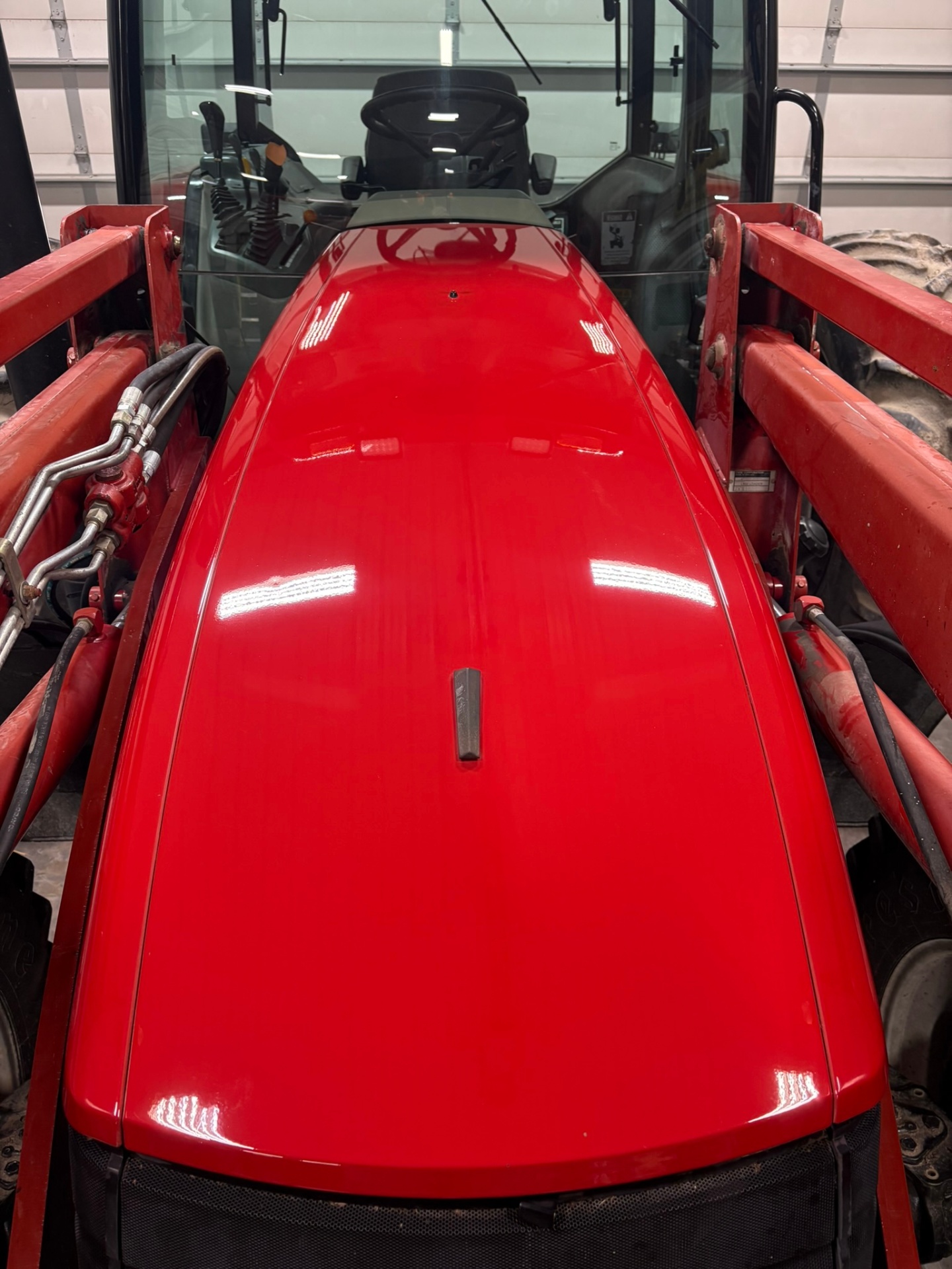 Restored glossy red tractor hood